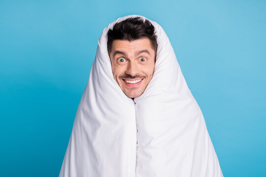 Photo Portrait Of Positive Smiling Guy Wrapped In Blanket Isolated On Vivid Blue Colored Background