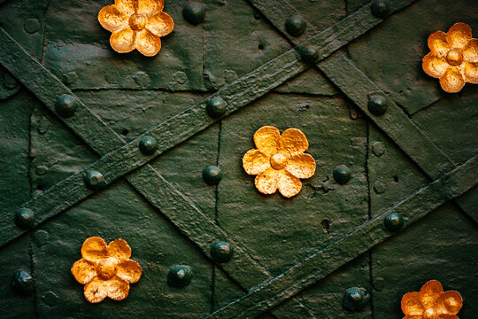 Vintage metal green door decorated with gold flowers