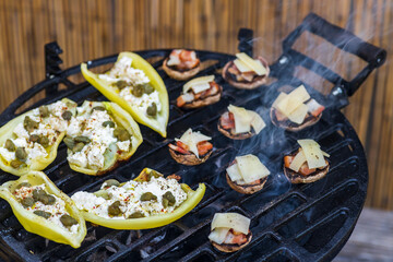 grilled peppers with feta cheese and capers and mushrooms with bacon baked with Emmental cheese
