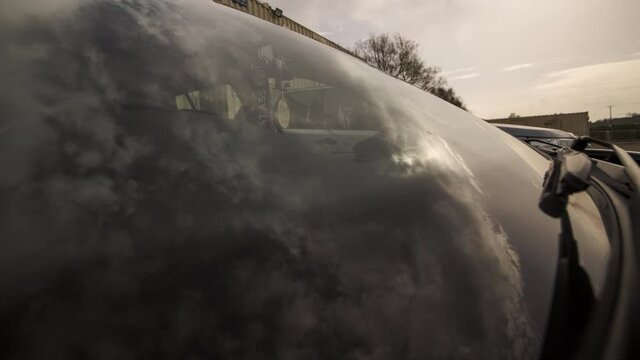 timelapse of clouds reflected in a car windscreen on a lovely sunny day.