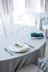 glass glasses and a white plate with a napkin on the table