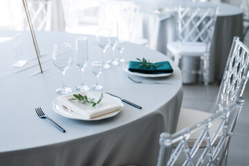 glass glasses and a white plate with a napkin on the table
