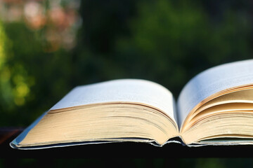 Open book in a garden. Selective focus.