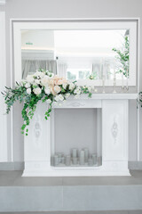 white fireplace with plaster patterns decorated with white and peach flowers