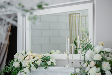 white fireplace with plaster patterns decorated with white and peach flowers