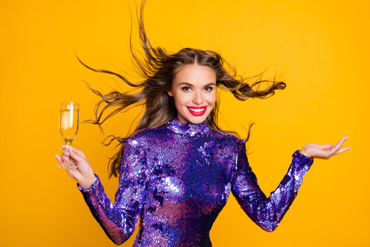 Photo portrait of shiny woman wearing glossy purple dress keeping champagne glass isolated vivid yellow color background