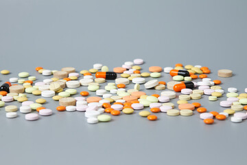 Colorful pills on a gray background. The concept of drug diversity in the modern world