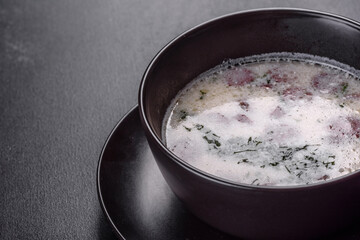 Cheese soup with fried sausages and herbs. Tasty cream cheese soup