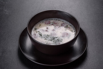 Cheese soup with fried sausages and herbs. Tasty cream cheese soup