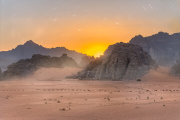 A Magical Sunset and Star trails Over the Golden Sand of Wadi Rum - Jordan.  