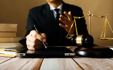 Business and lawyers discussing contract papers with brass scale on desk in office. Law, legal services, advice, justice and law concept picture with film grain effect