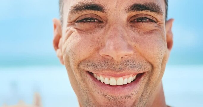Close up portrait of the young happy Brazilian surfer on the beach