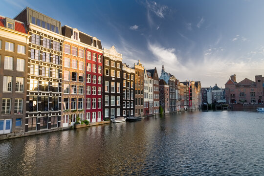 Damrak Waterfront seen at sunset time under a partially cloudy sky