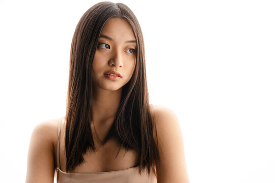 Young asian brunette woman posing and looking aside