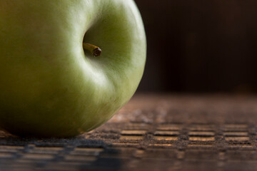 Ripe green apple on kitchen table