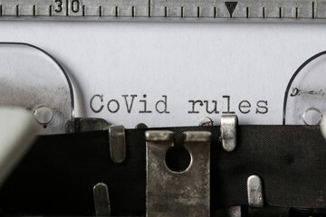 COVID Rules text on blank paper typed on a retro typewriter