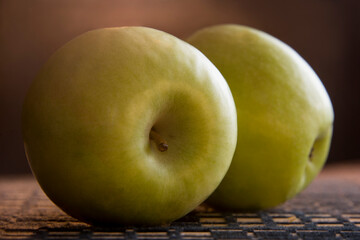 Ripe green apple on kitchen table