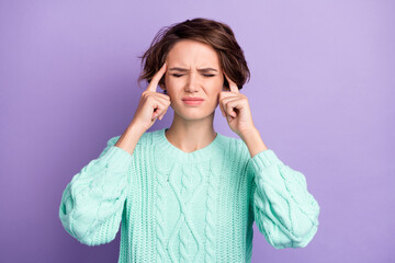 Portrait of attractive depressed brown-haired girl feeling bad touching temples isolated over violet purple color background