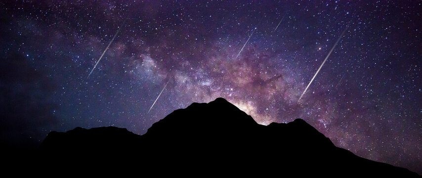 Panorama Milky Way. Night sky with stars and hooting stars with  silhouette of dark the mountain. Space background