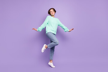 Full length body size view of attractive cheerful girl jumping having fun posing isolated over violet purple color background