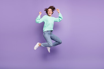 Full length body size view of attractive cheerful lucky girl jumping having fun rejoicing isolated over violet purple color background