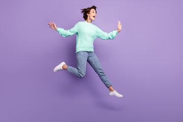 Fototapeta na wymiar Full size photo of young excited girl happy positive smile jump up look empty space isolated over purple color background