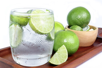 Cold Drink from Lemon cut into pieces in water glass on wood