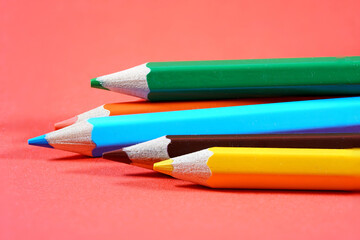 Colorful crayons, pencils with plain paper as a background with structure