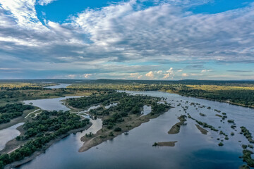 Majestic view of islands and submerged vegetation in the Zambezi River in Zambia with beautiful sky...