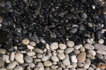 Black and white sea pebble stones on the beach