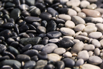 Black and white sea pebble stones on the beach