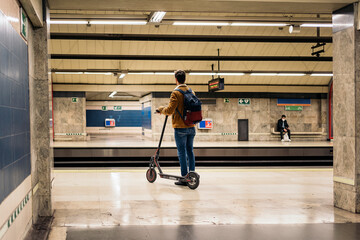Guy Walking With Electric Scooter In Underground Passage