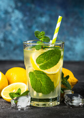 Lemonad in the glass at dark table.