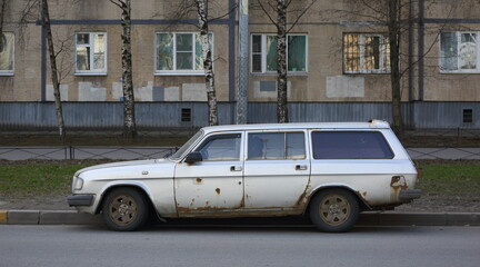 Old rusty Soviet car on the street, Iskrovsky Prospekt, Saint Petersburg, Russia, April 2021