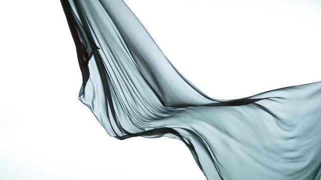 White transparent silk fabric flowing by wind, super slow motion