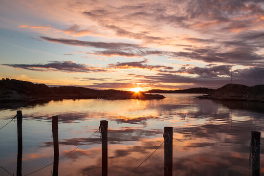 Horizontal view of sundown with blue sky and pink clouds in K&ouml;pstads&ouml;, Sweden, a small island of the Southern Gothenburg Archipelago (Swedish: G&ouml;teborgs sk&auml;rg&aring;rd)