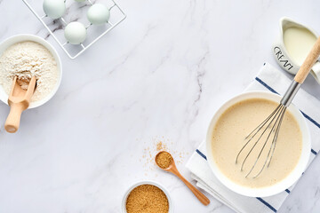 Preparation of dough for home pancakes for Breakfast or for Maslenitsa. Ingredients on the table - wheat flour, eggs, butter, sugar, salt, milk. Recipe step by step. Top view with place for text.