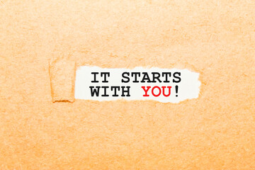 text IT STARTS WITH YOU on a torn piece of paper, business concept
