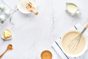 Preparation of dough for home pancakes for Breakfast or for Maslenitsa. Ingredients on the table - wheat flour, eggs, butter, sugar, salt, milk. Recipe step by step. Top view with place for text.