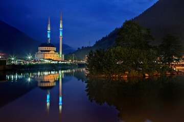 Fototapeta na wymiar A mosque reflected in Uzun lake (Uzungol), Trabzon Province, Black Sea region, Turkey.