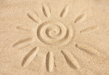 Fototapeta na wymiar Sun sign on sand under sunlight
