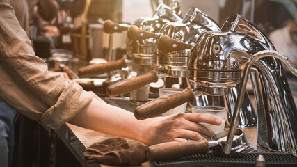 Barista Cafe Making Coffee Preparation Service Concept, coffee machine preparing fresh coffee and pouring into red cups at restaurant, Professional brewing.