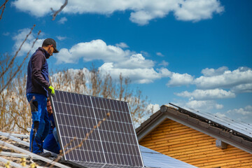 Installing solar photovoltaic panel system. Solar panel technician installing solar panels on roof....