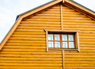 Fototapeta na wymiar The wall of a wooden house with one window.