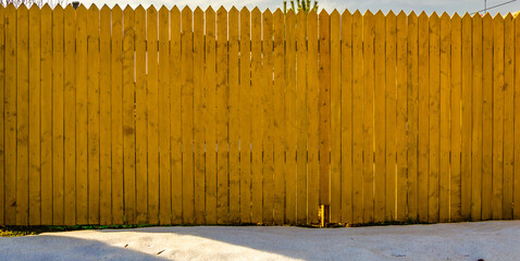 Wooden fence made of vertical boards.