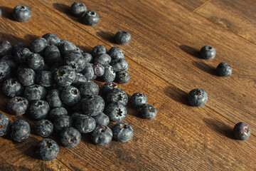 Blueberries with water drops. Desktop wallpaper. Health and freshness concept. Blueberries on a wooden background.