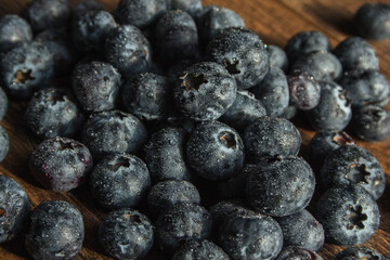 Blueberries with water drops. Beautiful macro photo of a berry. desktop wallpaper. Health and freshness concept.