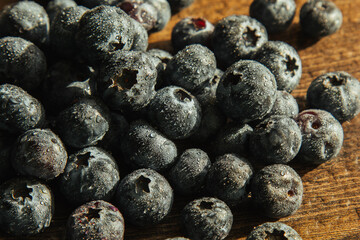 Blueberries with water drops. Health and freshness concept. Blueberries on a wooden background.