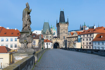 Fototapeta na wymiar Amazing Sunny day on Charles bridge and historical center of Prague, buildings and landmarks of old town, Prague, Czech Republic Prague during quarantine restrictions. Spring or summer time.