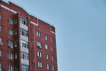 Red brick building with blue sky background